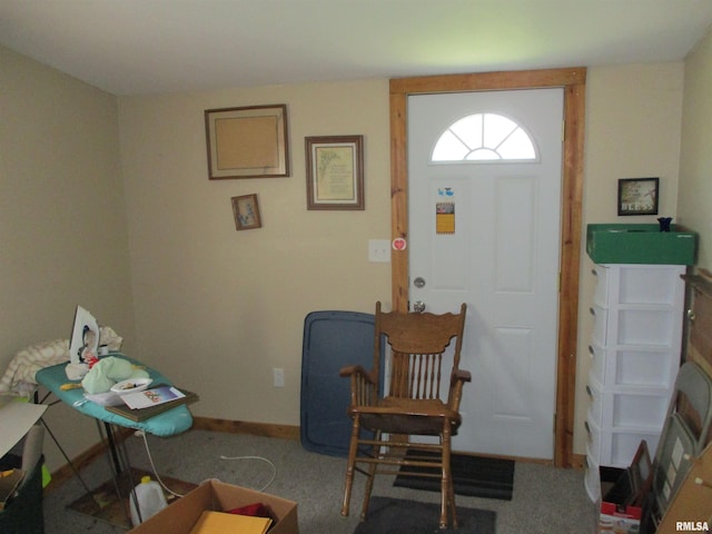 carpeted foyer featuring baseboards