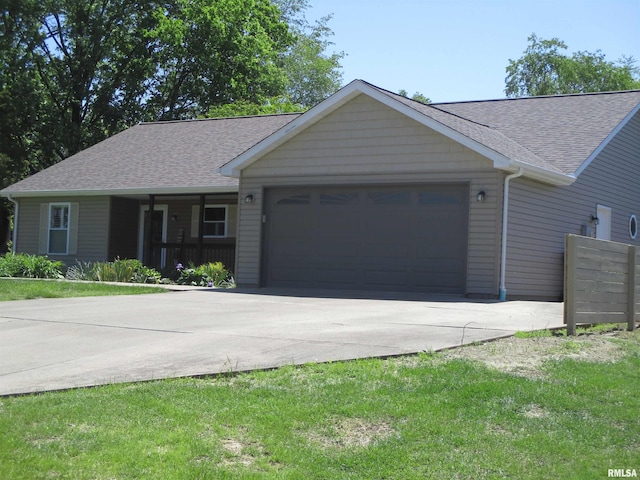 1607 Marion St, Carterville, IL 62918 - ranch-style home with a garage, concrete driveway, roof with shingles, and a front yard