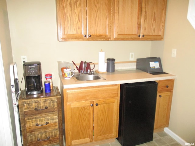 1607 Marion St, Carterville, IL 62918 - kitchen featuring a sink, light countertops, refrigerator, and baseboards