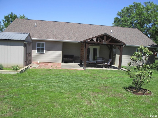 1607 Marion St, Carterville, IL 62918 - back of house with a patio area, a lawn, and roof with shingles