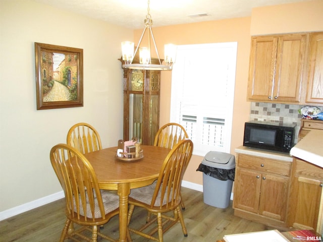 1607 Marion St, Carterville, IL 62918 - dining area featuring a chandelier, light wood-type flooring, and baseboards