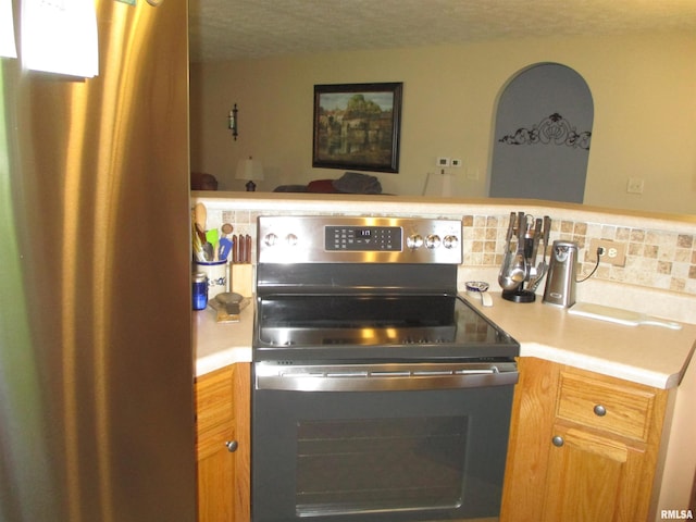 1607 Marion St, Carterville, IL 62918 - kitchen featuring stainless steel appliances, a textured ceiling, light countertops, and tasteful backsplash
