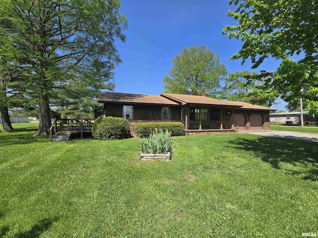 ranch-style home featuring a garage, driveway, and a front lawn