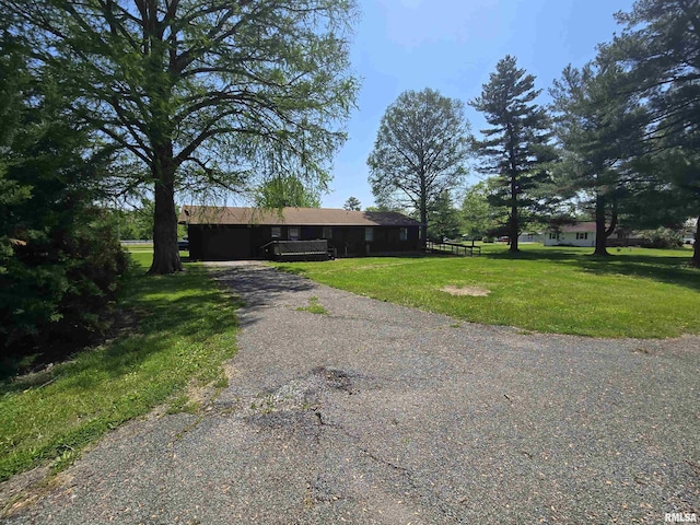 ranch-style home featuring a front yard