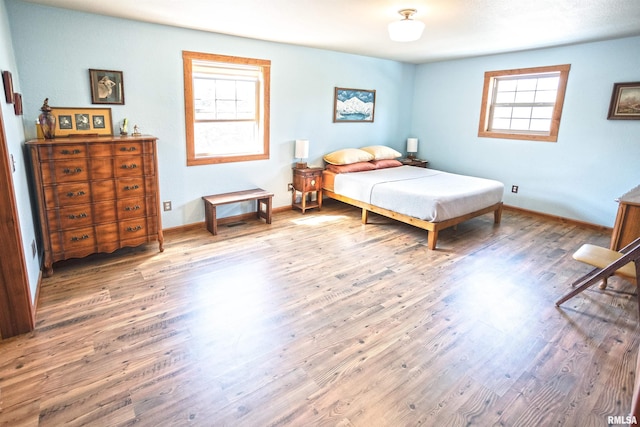 bedroom with wood finished floors and baseboards