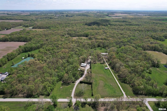 birds eye view of property featuring a wooded view and a water view