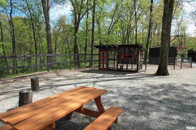 view of patio / terrace featuring an outbuilding, exterior structure, and fence