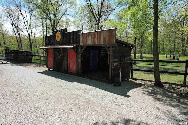 view of outdoor structure featuring fence and an outdoor structure