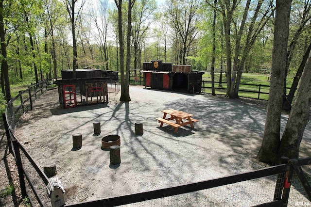 view of patio / terrace with fence and an outbuilding