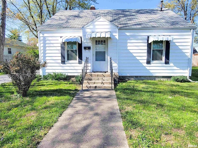 439 Fair Ave, Flora, IL 62839 - bungalow-style home with a chimney, a shingled roof, a front yard, and entry steps