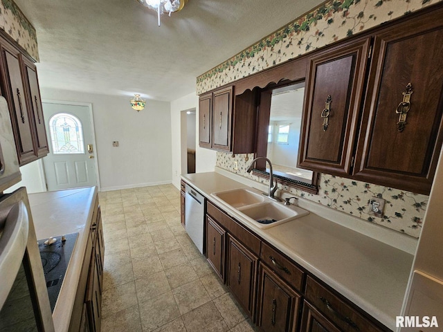 kitchen with a sink, baseboards, dark brown cabinetry, and dishwasher