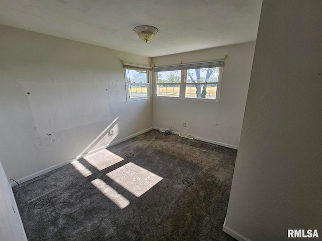 empty room with baseboards, carpet flooring, and visible vents
