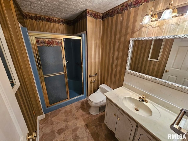 full bath with vanity, toilet, and a shower stall