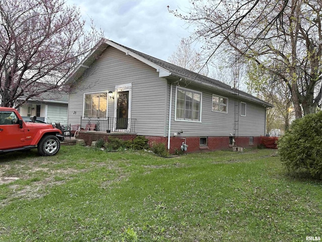 view of home's exterior with a yard