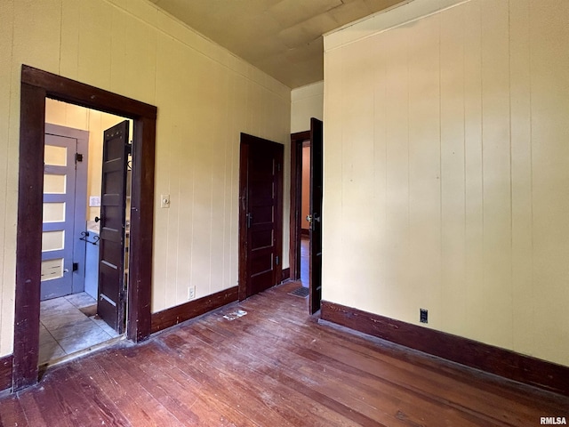 empty room featuring baseboards and hardwood / wood-style floors