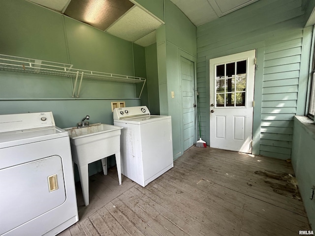laundry room with laundry area, light wood-type flooring, and washing machine and clothes dryer