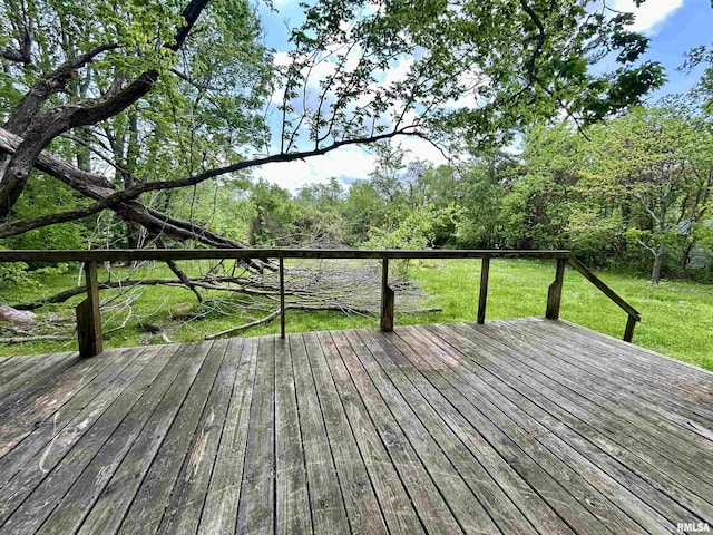 wooden terrace featuring a lawn