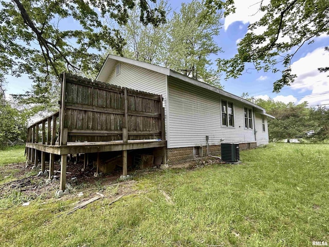 view of side of property with a yard and cooling unit