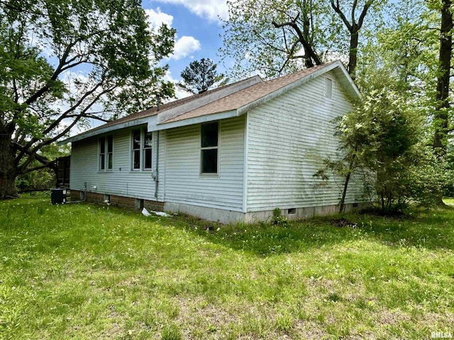 view of side of home with roof with shingles