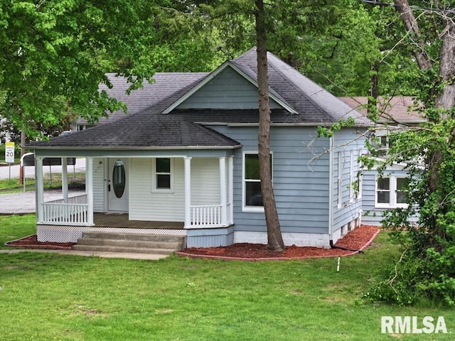 800 Division St, Carterville, IL 62918 - view of front of house with covered porch, driveway, a detached carport, and a front lawn
