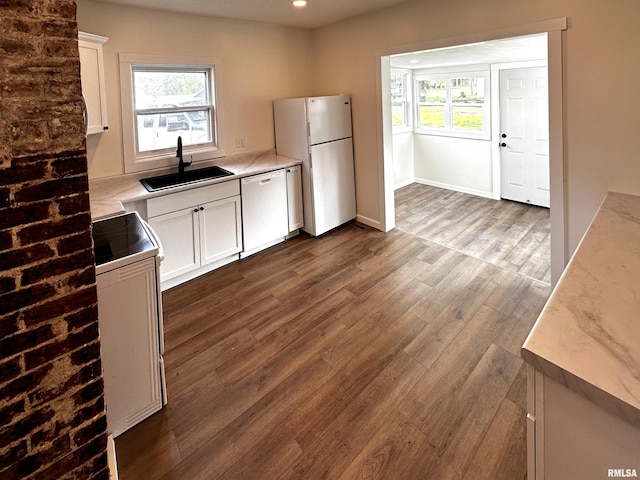 800 Division St, Carterville, IL 62918 - kitchen with a sink, white appliances, light countertops, white cabinetry, and dark wood-type flooring