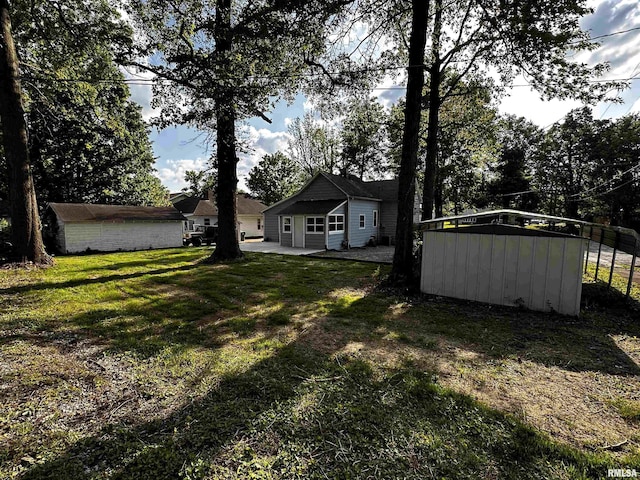 800 Division St, Carterville, IL 62918 - view of yard with an outdoor structure and a patio area