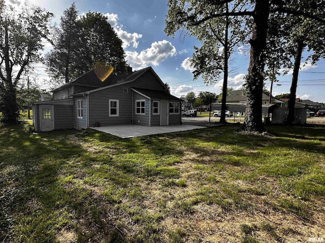 800 Division St, Carterville, IL 62918 - rear view of property featuring a lawn and a patio