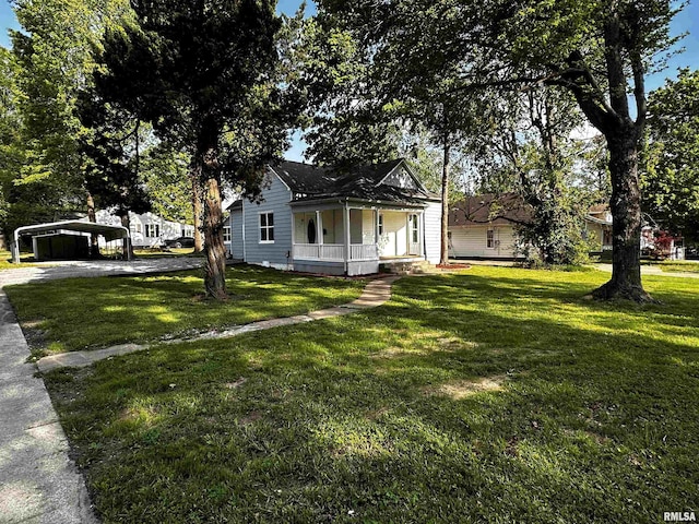 800 Division St, Carterville, IL 62918 - view of front facade with covered porch, driveway, a front yard, and a detached carport