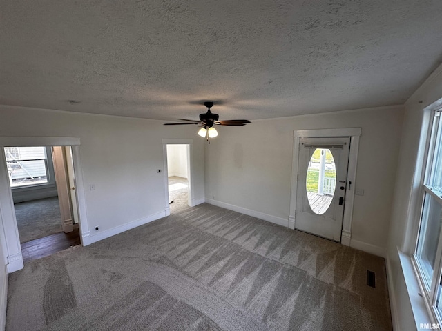 800 Division St, Carterville, IL 62918 - carpeted entrance foyer featuring a ceiling fan, a textured ceiling, and a wealth of natural light