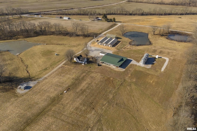 birds eye view of property with a water view and a rural view
