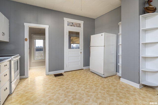 kitchen with baseboards, open shelves, white appliances, and visible vents