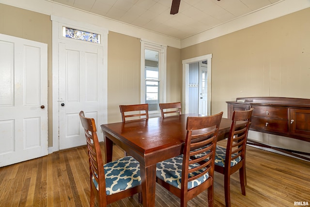 dining space with ceiling fan and hardwood / wood-style flooring