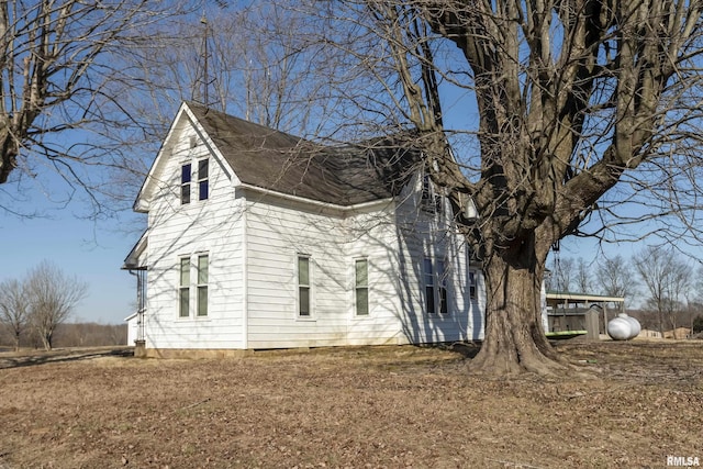 view of home's exterior with roof with shingles