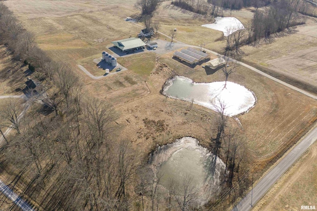 birds eye view of property with a rural view