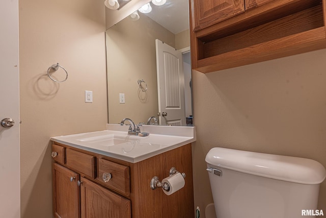 half bathroom with vanity and toilet