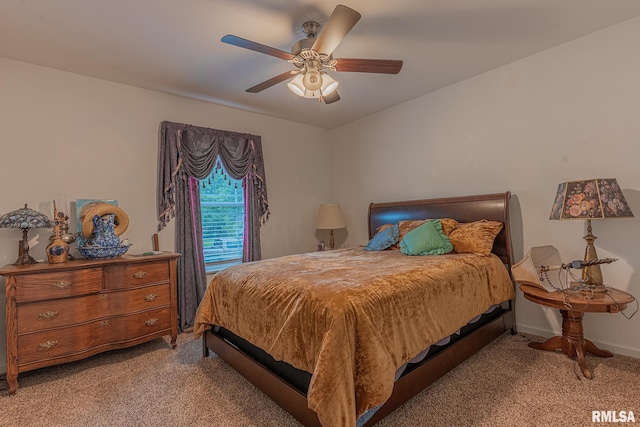 bedroom with a ceiling fan, baseboards, and light carpet