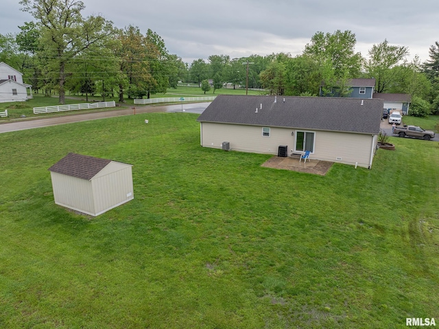 view of yard with a storage unit, a patio, an outdoor structure, and cooling unit