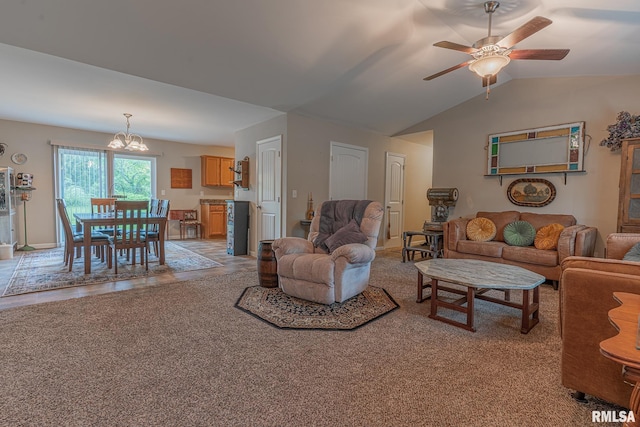 living room featuring vaulted ceiling, ceiling fan with notable chandelier, and light colored carpet