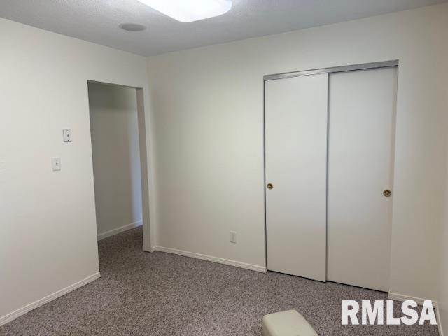 301 S Pershing St, Energy, IL 62933 - unfurnished bedroom with baseboards, carpet, and a closet