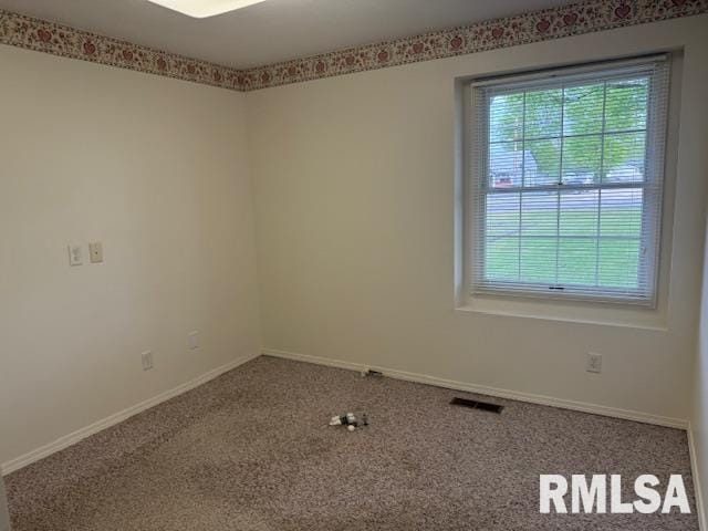 301 S Pershing St, Energy, IL 62933 - carpeted spare room with baseboards, visible vents, and a wealth of natural light