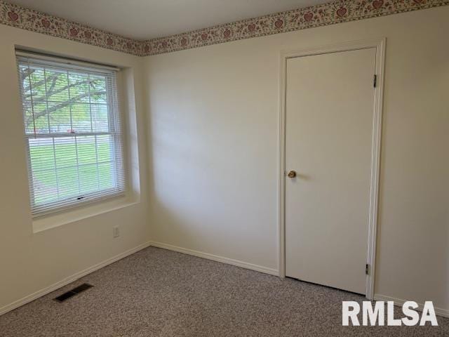 301 S Pershing St, Energy, IL 62933 - carpeted empty room with baseboards and visible vents