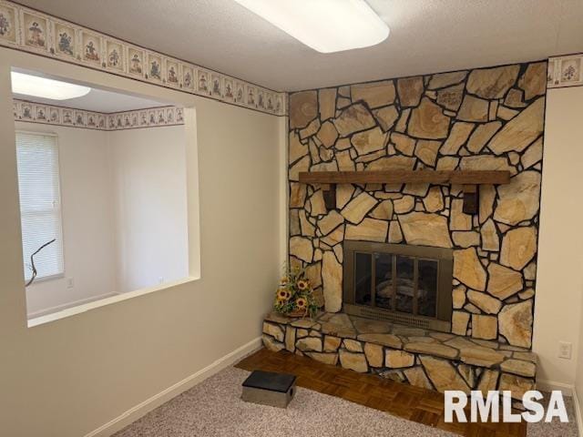 301 S Pershing St, Energy, IL 62933 - unfurnished living room featuring baseboards and a stone fireplace