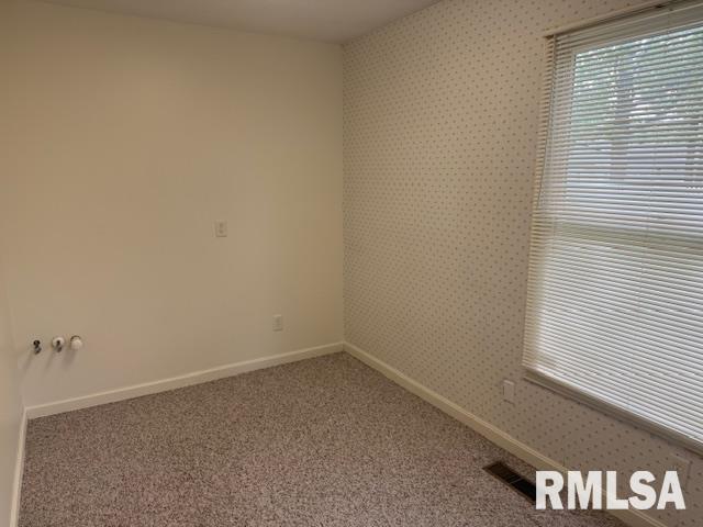 301 S Pershing St, Energy, IL 62933 - spare room with visible vents, carpet, baseboards, and wallpapered walls
