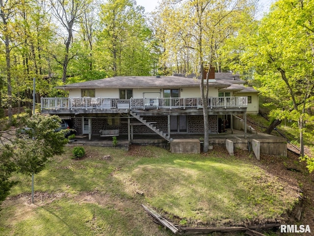 back of property with stairs, a chimney, a yard, and a deck