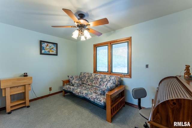 living area featuring baseboards, a ceiling fan, and carpet flooring