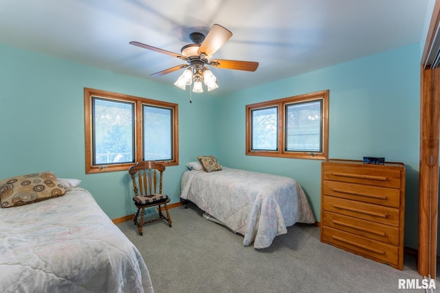 carpeted bedroom featuring ceiling fan and baseboards