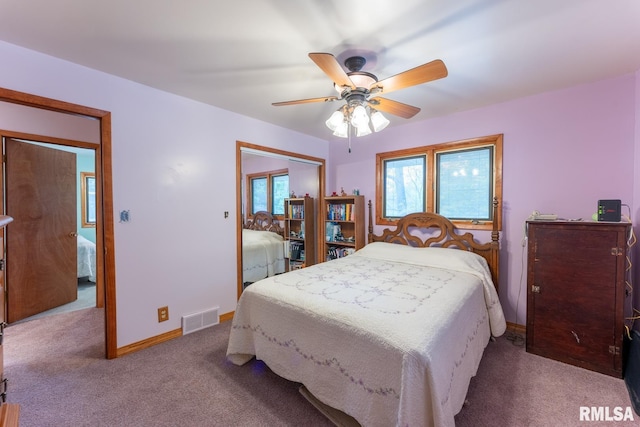carpeted bedroom with baseboards, a ceiling fan, a closet, and visible vents