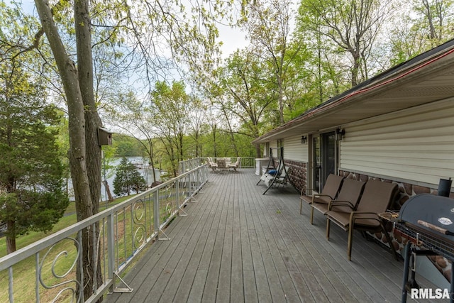 wooden deck featuring a water view and grilling area