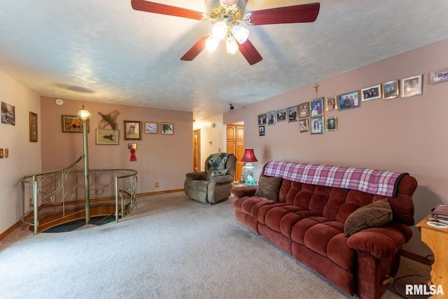 carpeted living room with ceiling fan and baseboards
