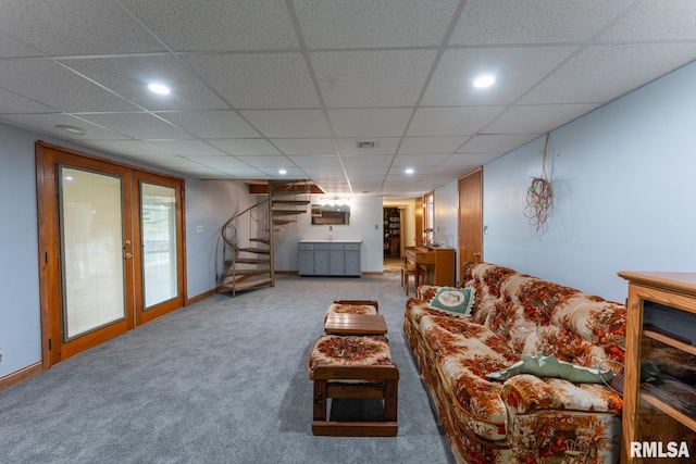 carpeted living area with recessed lighting, stairs, and a paneled ceiling